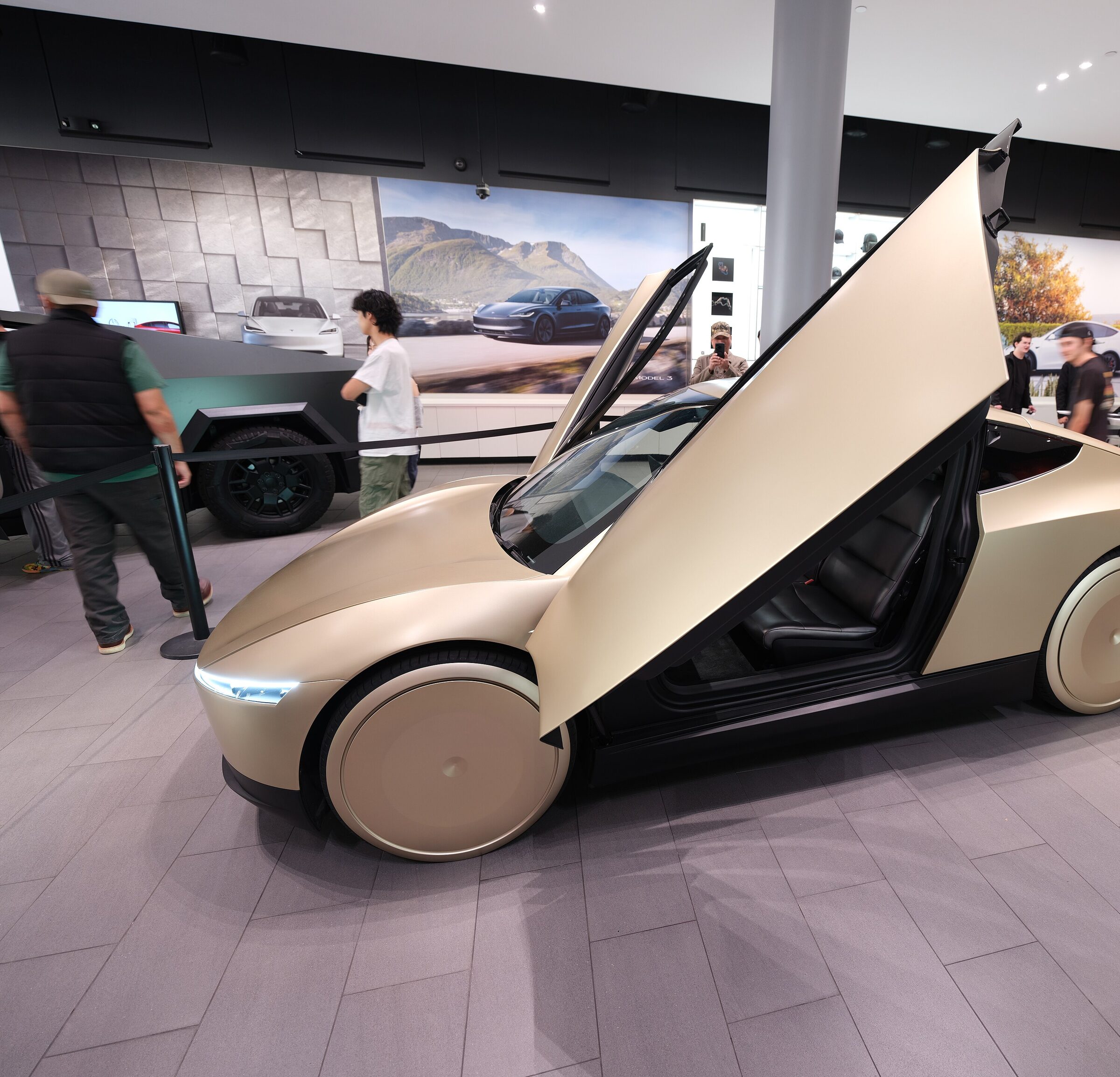 Tesla Cybercab at an oblique angle, butterfly doors open.