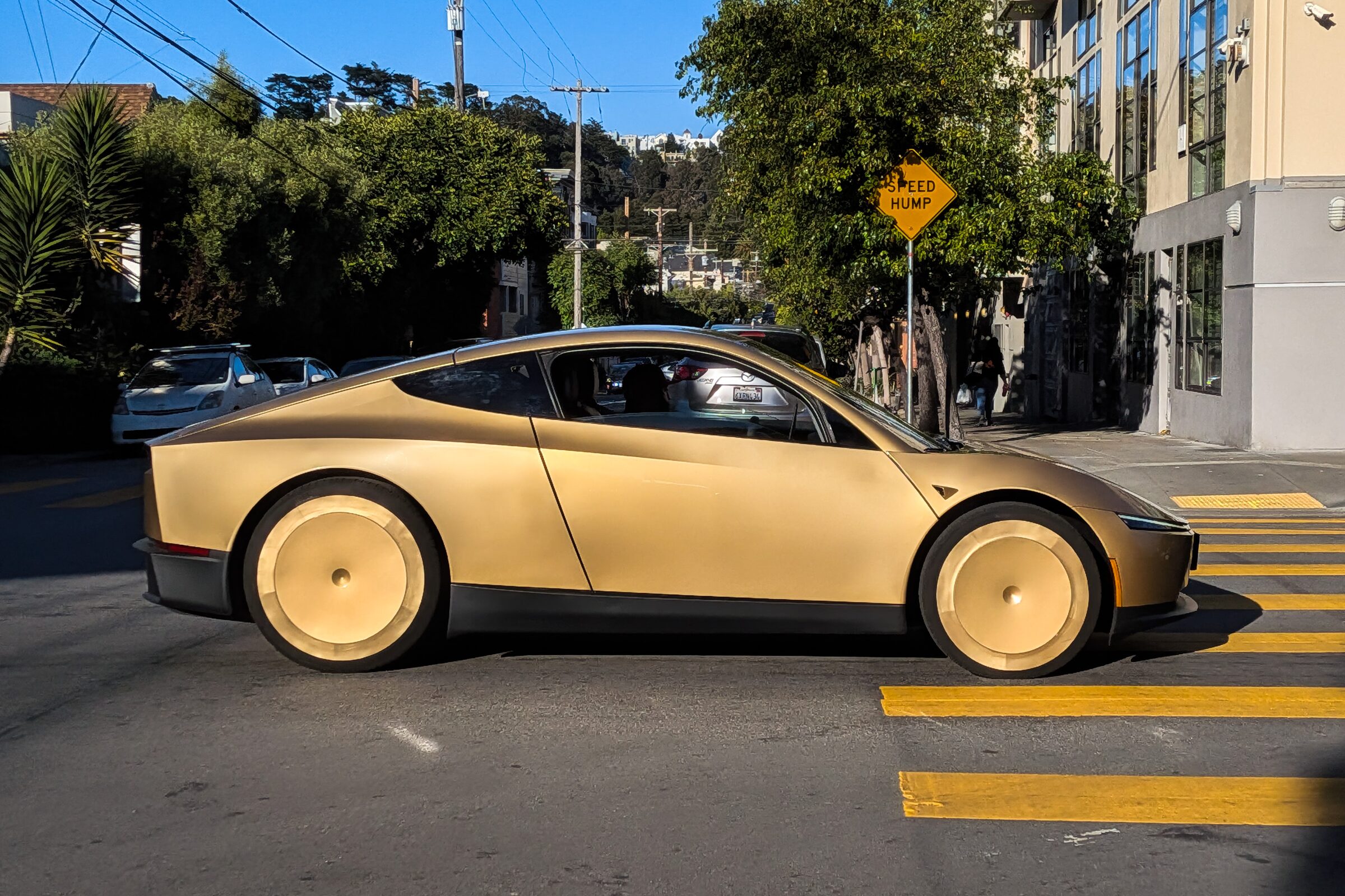Tesla Cybercab in motion on a San Francisco street.